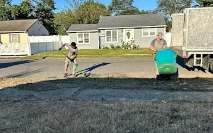 Crew clearing storm debris from a Kansas City driveway